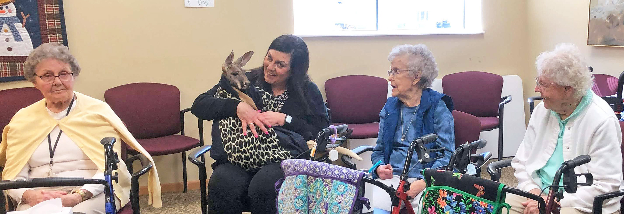 Park Place seniors are enthralled with a visit from a kangaroo from Tiny Acres Farm in Muscoda.