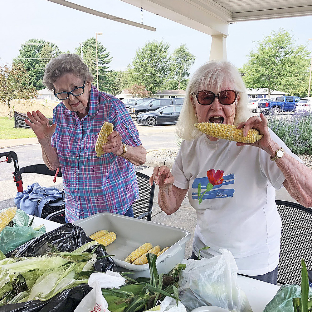 Park Place Assisted Living folks husk sweet corn